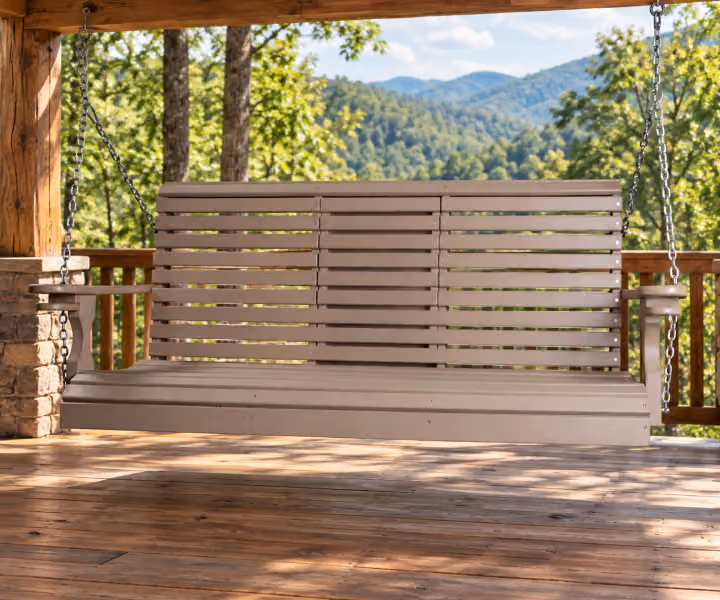 Willow Bay Poly Curved-back Swing on a covered mountain cabin porch
