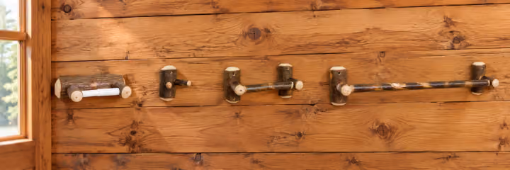 Hemlock Ridge Hickory Four-Piece Bathroom Accessory Set in a rustic cabin setting