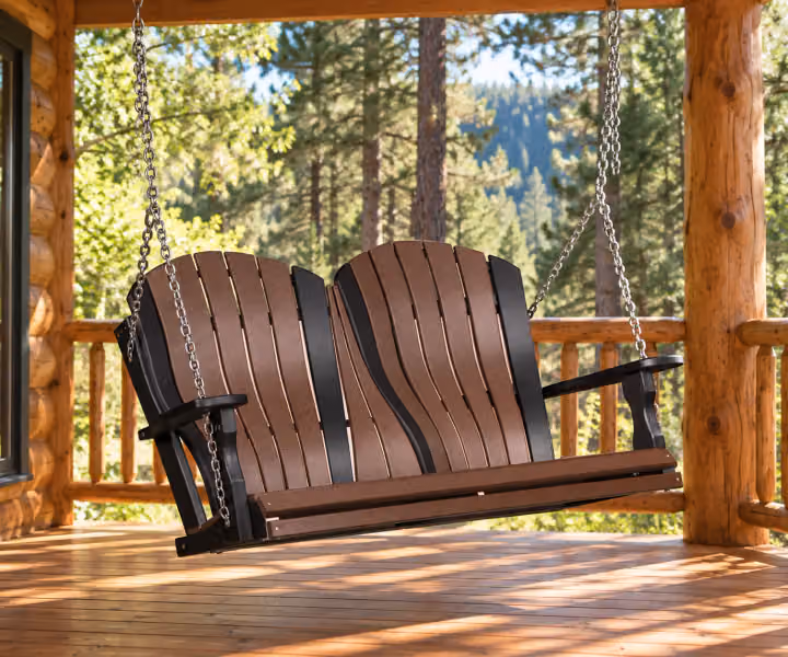 Harbor Porch Arched-back Poly Double Porch Swing in an outdoor cabin setting