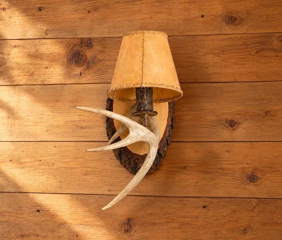 Woodland Shaded Antler Wall Sconce in a rustic cabin