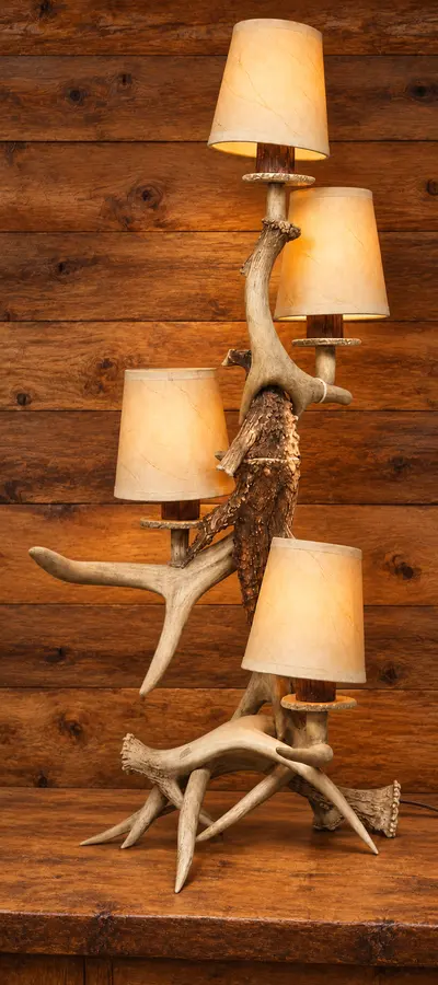 Whitetail Four-Light Tower Lamp in a rustic cabin